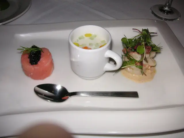 A seafood trio plated as a first course at a restaurant table.