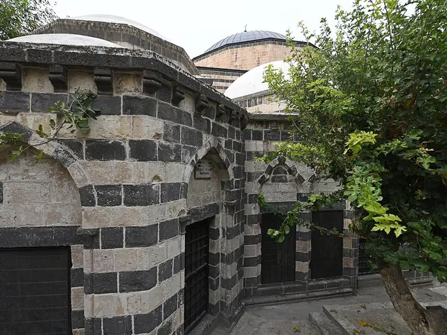 The exterior of a domed mosque with striped stonework