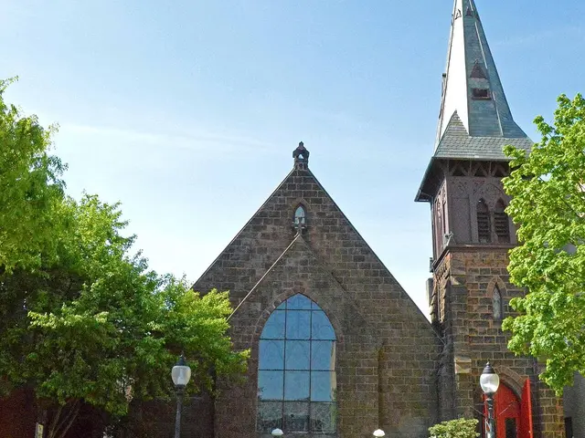 Exterior of Christ Episcopal Church, a stone church building with a spire in Pottstown, Pennsylvania.