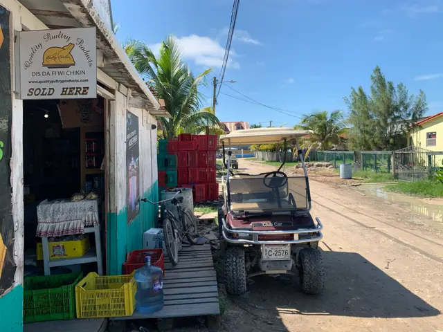 The exterior of a small corner grocery store along a dirt road.