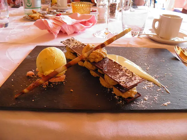 A millefeuille dessert plated at a restaurant table.
