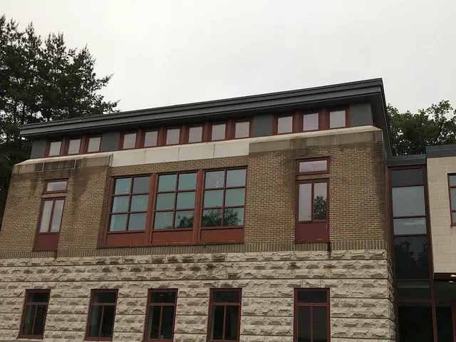 Brick and stone academic building of St. Vladimir's Orthodox Theological Seminary with a wall-mounted seminary crest.
