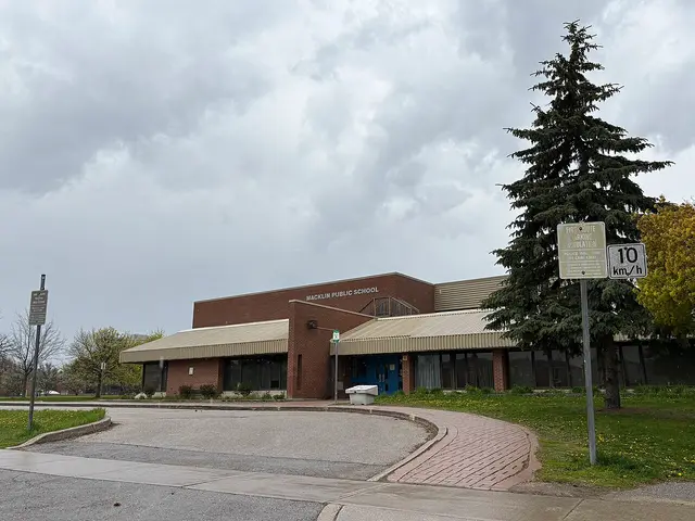 The exterior of Macklin Public School, a brick elementary school building with its name on the facade