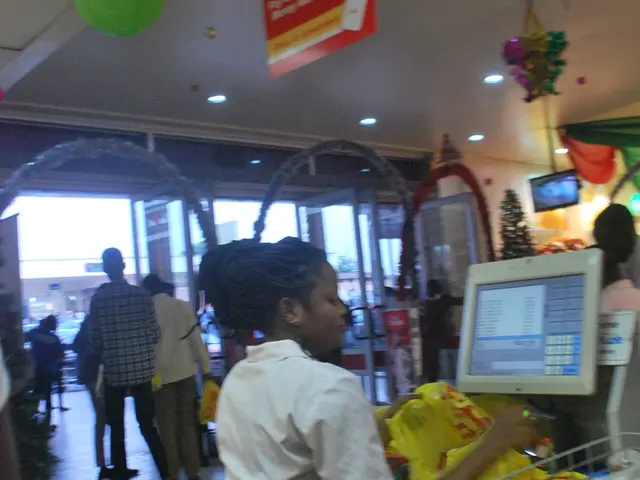 A cashier working at the checkout counter of a grocery store.