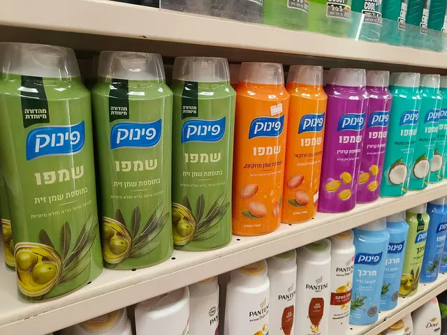 A grocery store aisle lined with shampoo and other personal care products on shelves.