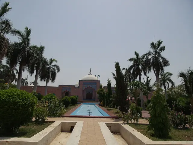 A mosque seen across a garden reflecting pool
