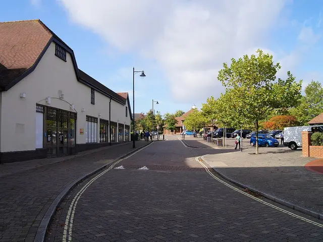 Exterior of a supermarket building with its storefront and parking area visible.