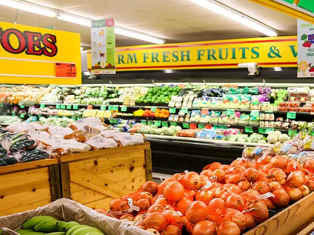 The produce section of a grocery store with fruit displayed for sale.