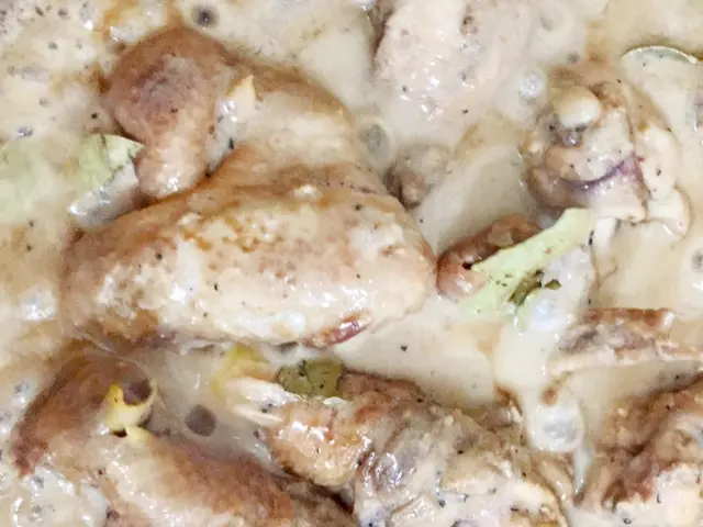 A plate of chicken adobo cooked with coconut milk.