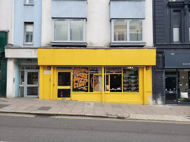 Shopfront of an independent pizza takeaway shop.