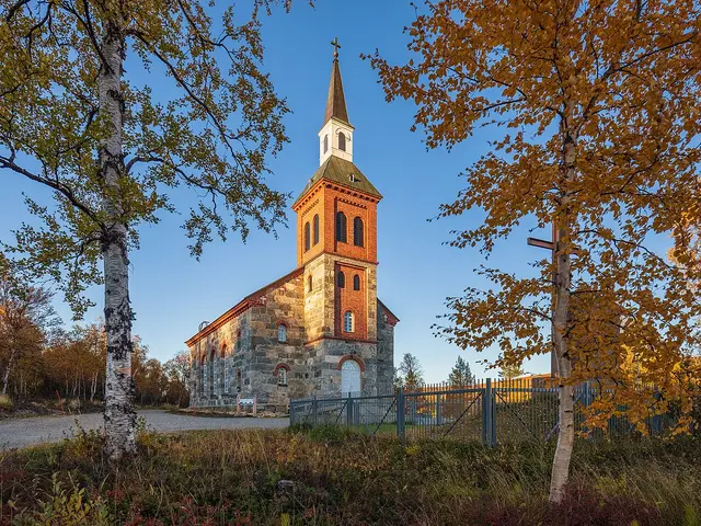 The exterior of a simple wooden church building in a northern landscape.