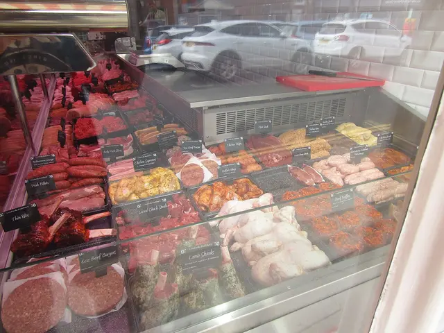 Meat display counter inside Coxford's Butchers shop in Aylsham, England.