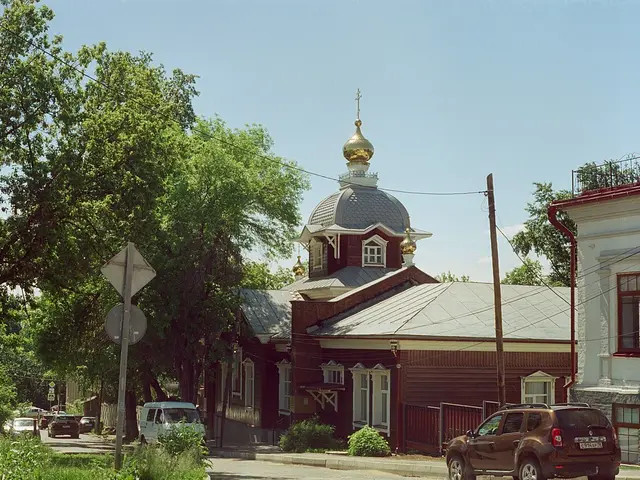 The exterior of a small wooden church building with a peaked roof.
