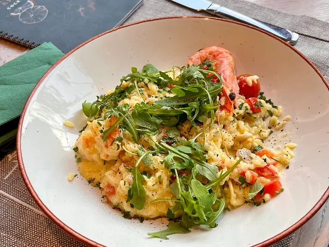 A plate of seafood risotto served at an Italian trattoria in Warsaw.