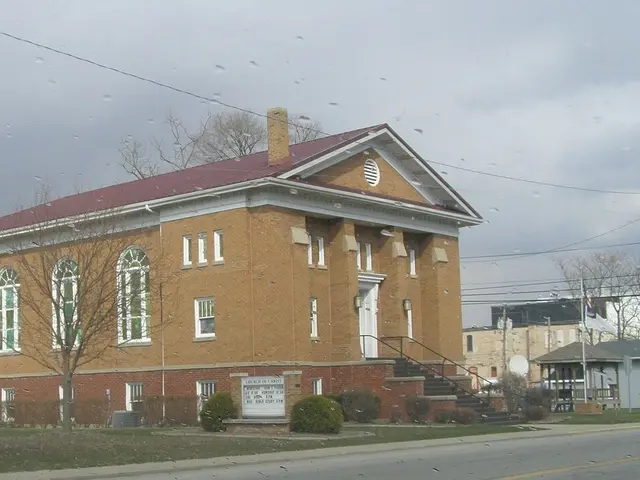 Brick Church of Christ building with a gabled portico and columned entrance in Montpelier, Indiana.