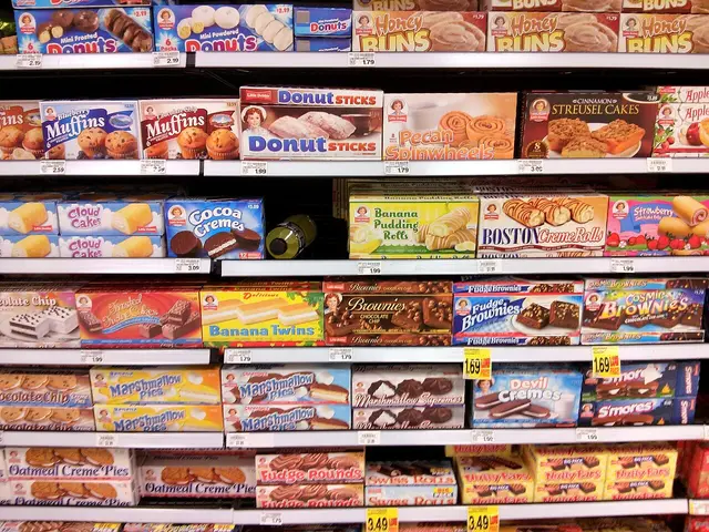 Grocery store shelves stocked with packaged snack foods.