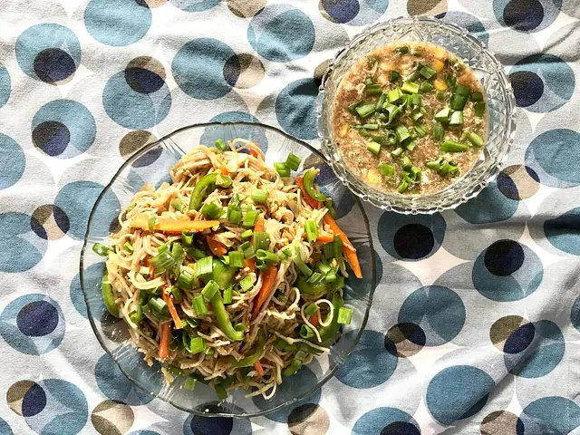 A home-cooked dish of stir-fried noodles served with Chinese soup.