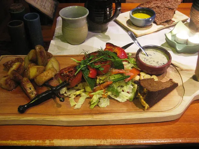 A plated main course with grilled vegetables served at a restaurant table.