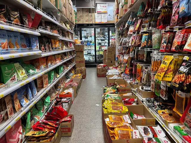 An aisle inside Daily Market Groceries, an Asian supermarket in Canberra City, Australia, with shelves stocked with packaged goods.