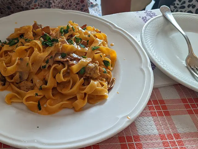 A plate of pork tagliatelle pasta served at a restaurant in Rome, Italy.