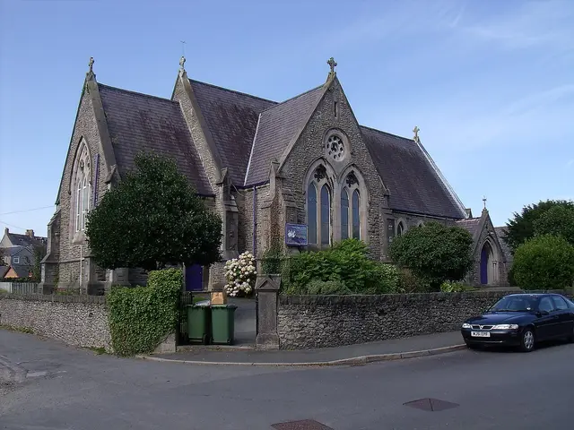 Assemblies of God Pentecostal Church in Bangor, Wales, a stone Gothic-style chapel with three gabled bays and a rose window, seen from the street corner.