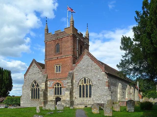 The exterior of a stone parish church with a tower and surrounding churchyard.