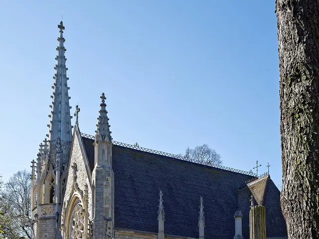Exterior of the Anglican chapel at the City of London Cemetery and Crematorium, a Gothic stone building with a tall spire.