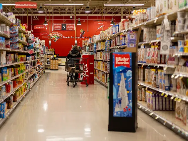 A long grocery store aisle lined with shelves of packaged food inside a Hannaford supermarket in Vermont.