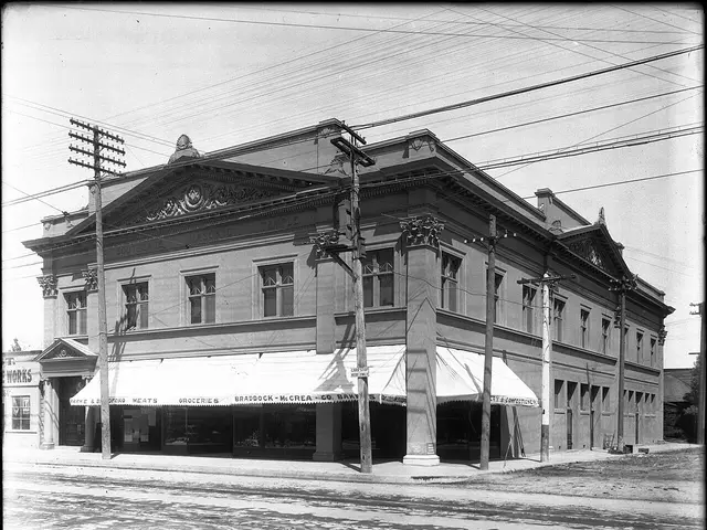 A historic building exterior with a grocery store occupying the ground floor.