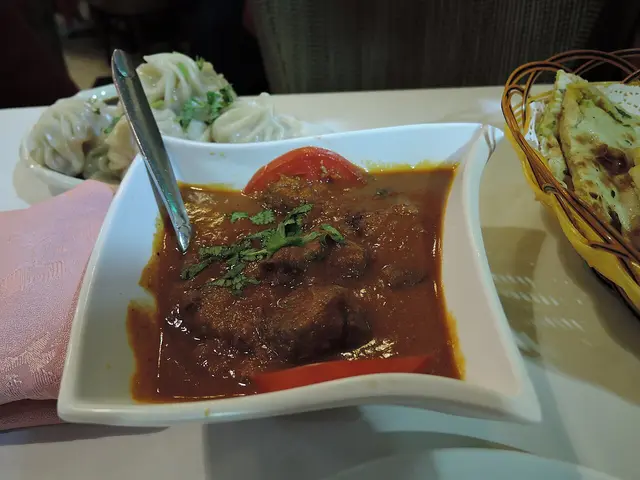 A bowl of lamb curry served at an Indian curry house.