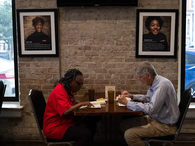 Customers looking at their menus before ordering at a restaurant in New Orleans.