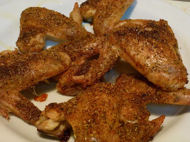 Seasoned chicken wings served on a plate.