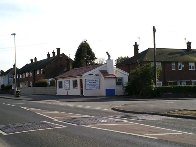 Exterior of a fish and chip shop on a housing estate parade.