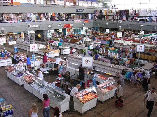 Butcher stall with meat on display inside a large market hall in Kiev, Ukraine.