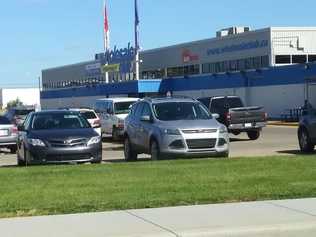 Exterior of a Wholesale Club warehouse food store in Edmonton, with cars parked in front.