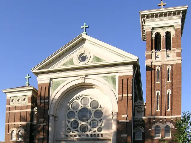 Exterior of St. Charles Borromeo Roman Catholic Parish in Detroit, Michigan, a brick church with twin bell towers and a large rose window.