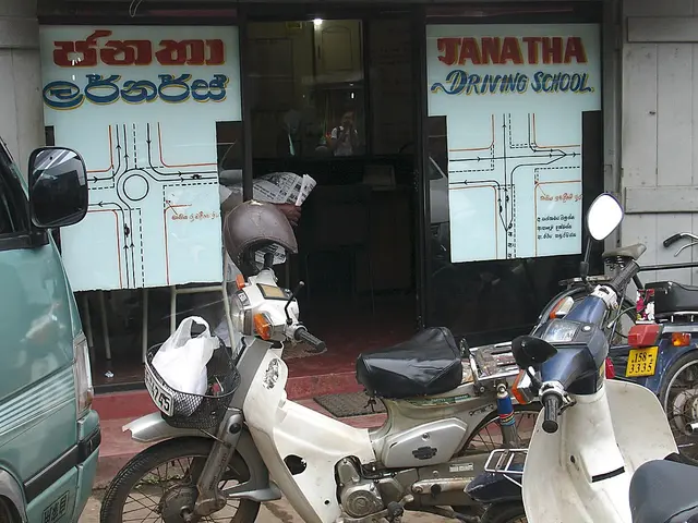 The storefront of Janatha Driving School in Sri Lanka, with road-junction diagrams painted on the windows.