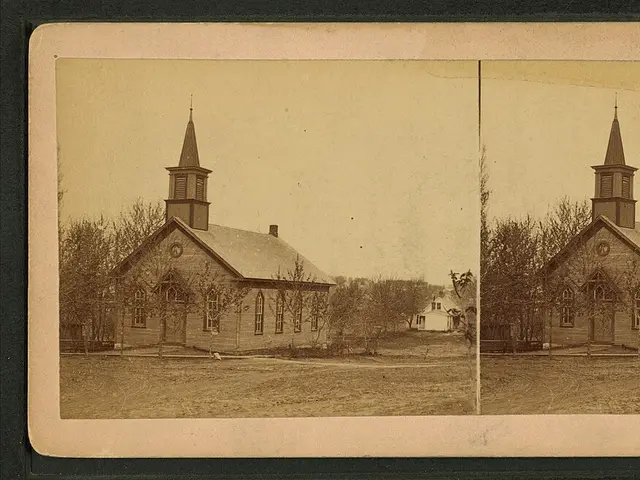 The exterior of a small town church building with a steeple.