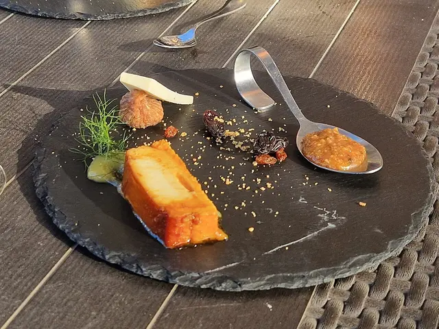 A selection of desserts plated at a restaurant table.