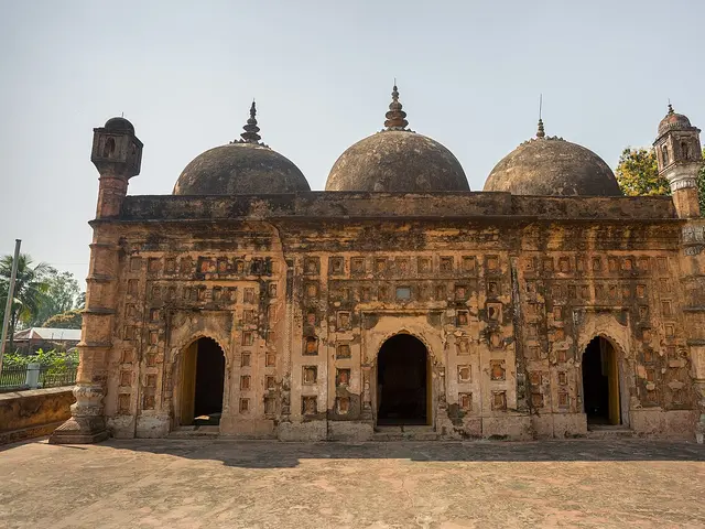 A terracotta-decorated mosque with three domes