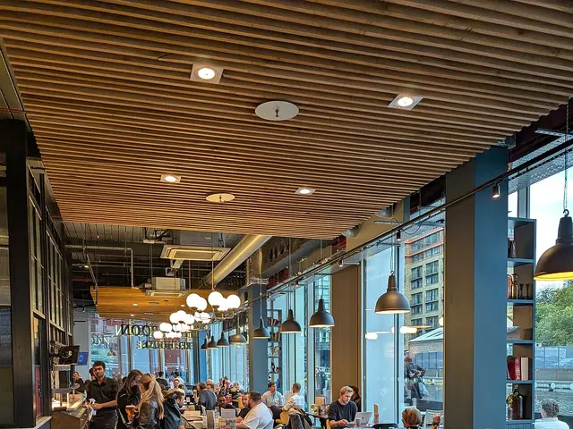 Interior of the Sir Alexander Fleming pub in Paddington, London, showing the seating area.