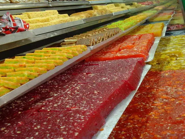 A display case of about a dozen varieties of barfi and other Indian sweets in a mithai shop in Kolkata, West Bengal.