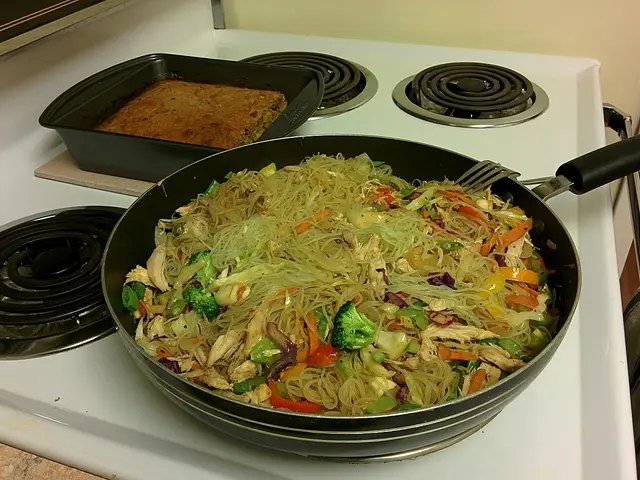 A plate of Chinese stir-fried noodles with mixed vegetables.