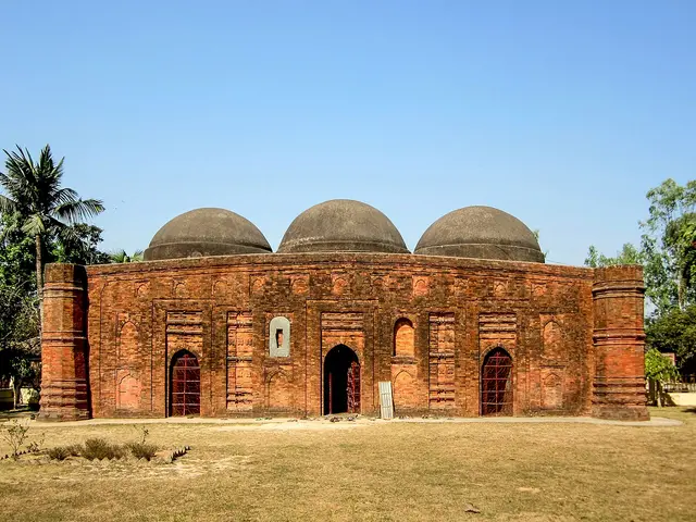 A brick mosque with three domes