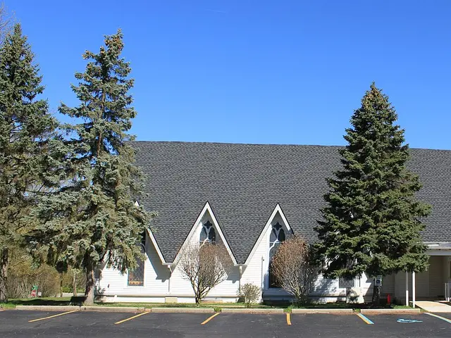 The Korean Church of Ann Arbor, Michigan, a white wood-sided church building with twin gothic gables, surrounded by evergreen trees.