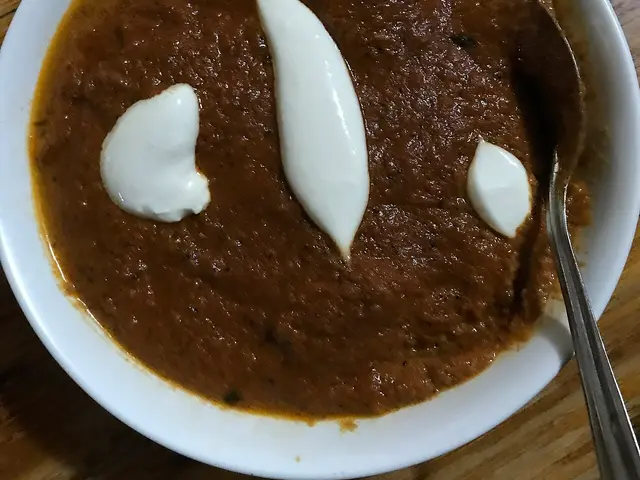 A dish of chicken butter masala, a popular Indian curry made with chicken in a creamy tomato sauce.