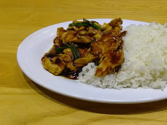 Mongolian-style stir-fried chicken with scallions and rice served at a Pei Wei restaurant.