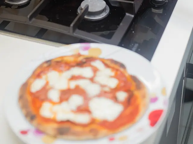 A round pizza topped with tomato sauce, cheese, and mixed toppings.