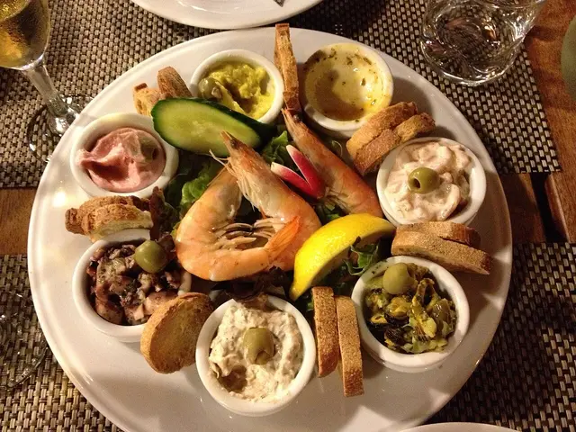 A plate of seafood served at a restaurant table.