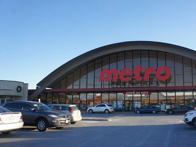 Metro supermarket exterior with a curved glass facade and red Metro signage above the entrance